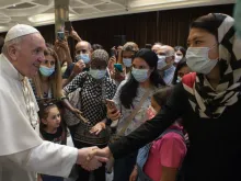 Pope Francis greets people after a documentary screening at the Vatican’s Paul VI Hall, Sept. 6, 2021.